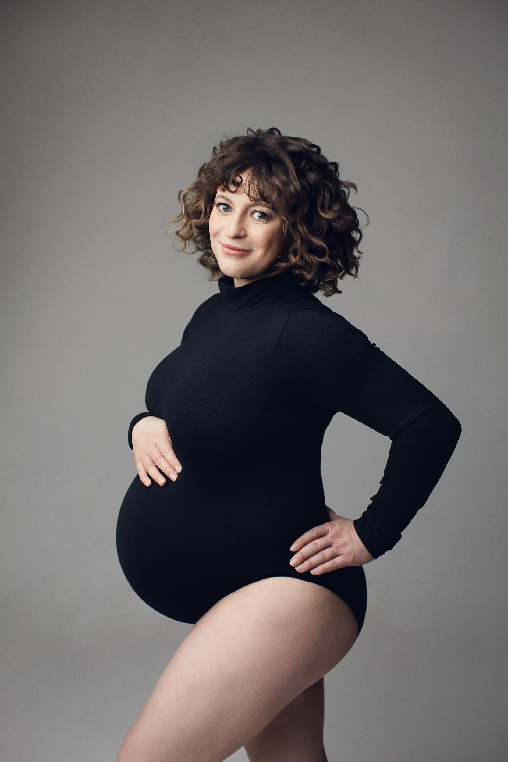 Stylish studio maternity photography with fitted bodysuit in Vancouver