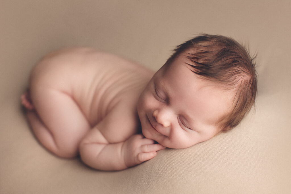 Sleeping newborn in teal wrap by Jana Photography serving Burnaby BC families