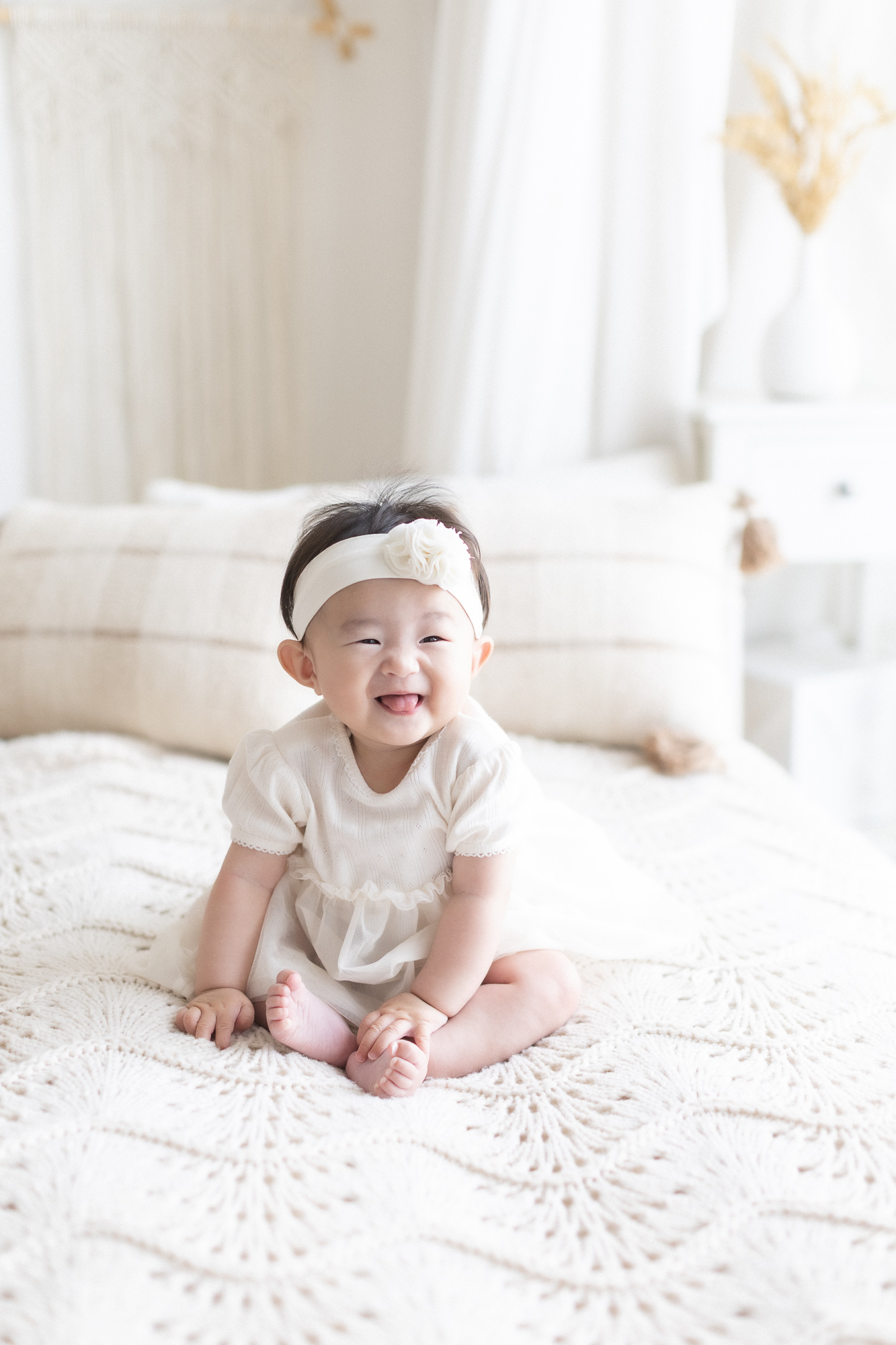Baby sitting up smiling during a baby sitter session in Vancouver