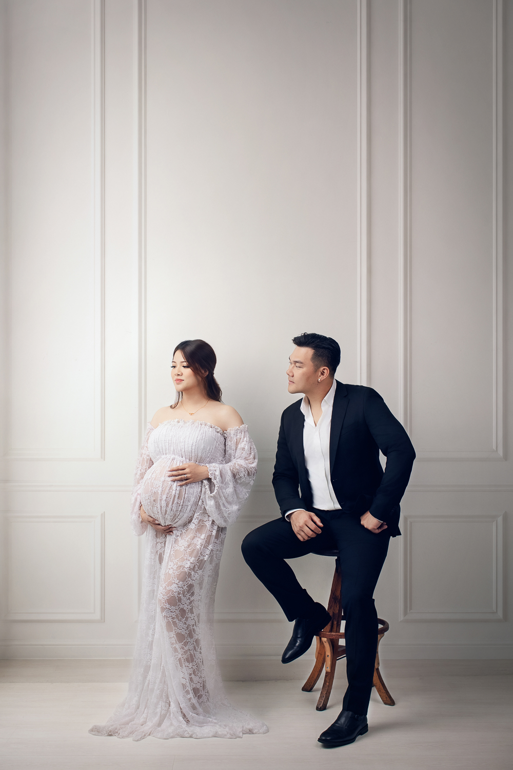 Best time to book maternity photos — couple in elegant lace gown and suit for a Vancouver studio maternity shoot