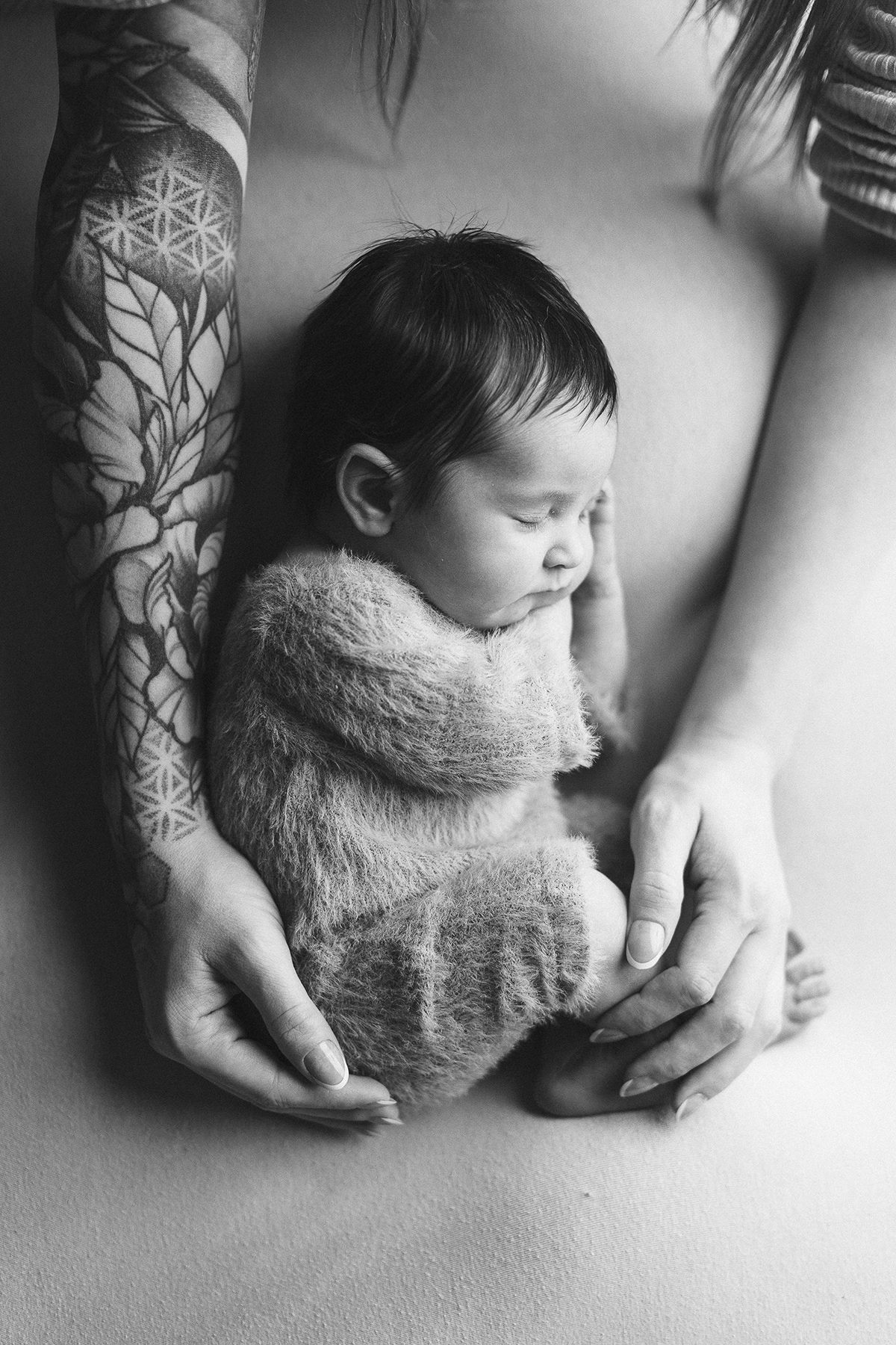 Mother tenderly holding newborn baby, black and white newborn photography Vancouver