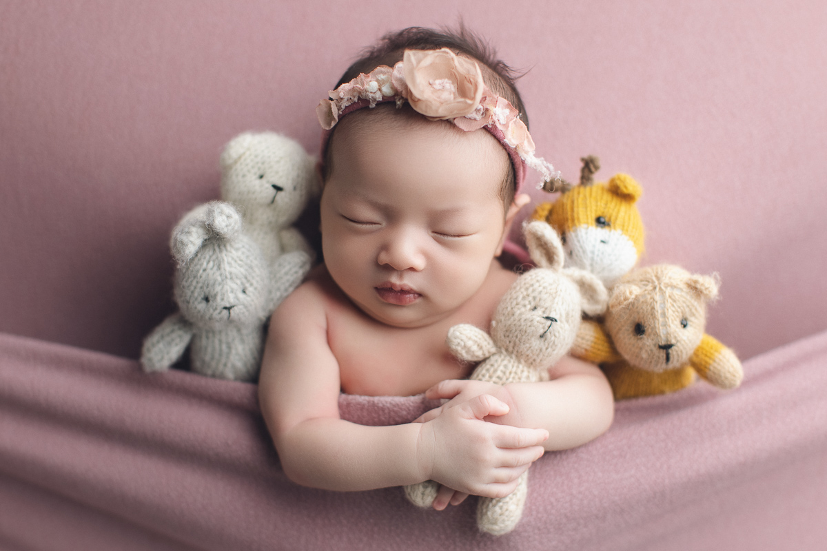 Vancouver newborn photography session — newborn baby surrounded by teddy bears