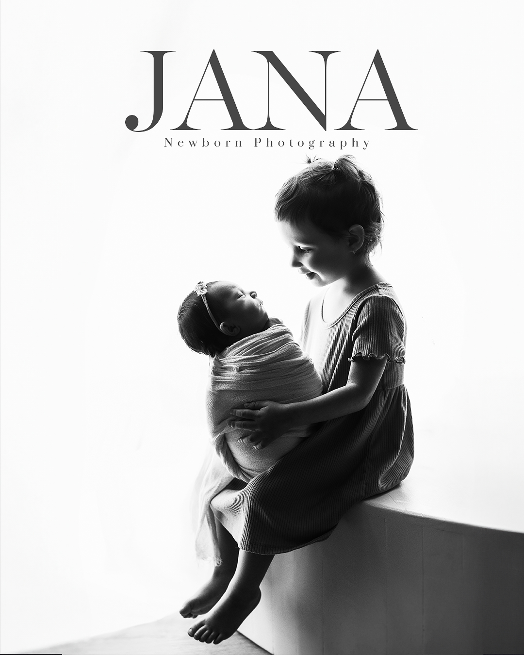 Toddler sibling holding newborn baby in a silhouette portrait, Vancouver newborn photography