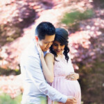 pregnancy photo with a couple in a spring background